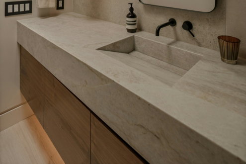 Modern bathroom vanity with integrated sink and black faucet.