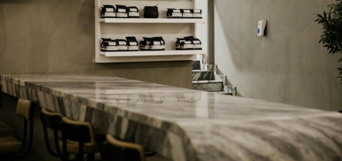 a counter in a restaurant with several chairs